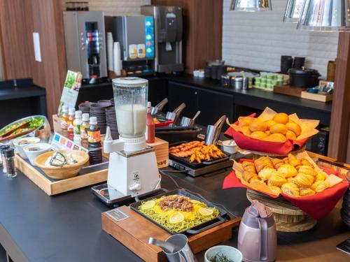 a buffet of food on a counter in a restaurant at Super Hotel Premier Shimonoseki in Shimonoseki