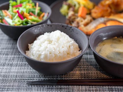 a group of bowls of rice on a table at Super Hotel Premier Shimonoseki in Shimonoseki
