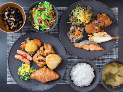 a group of plates of food on a table at Super Hotel Premier Shimonoseki in Shimonoseki