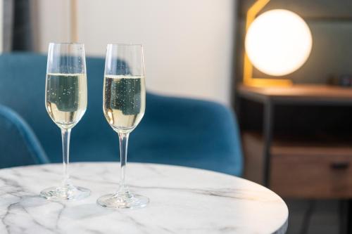 two glasses of champagne sitting on a table at Littomore Suites Bathurst in Bathurst