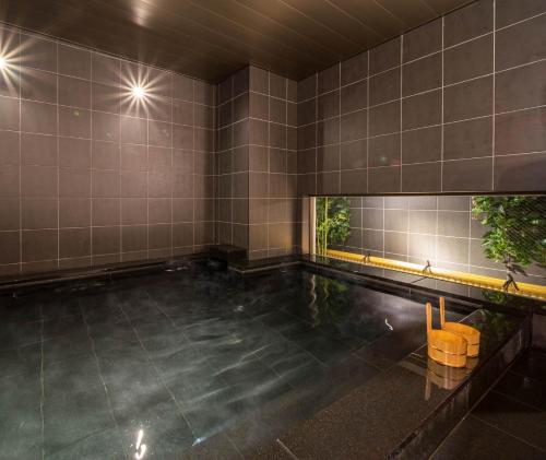 an empty swimming pool with a tile wall at Super Hotel Premier Shimonoseki in Shimonoseki