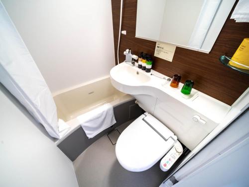 a small bathroom with a toilet and a sink at Super Hotel Premier Shimonoseki in Shimonoseki