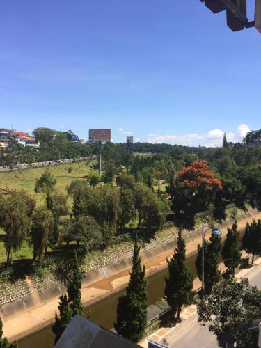 a view of a park with trees and a road at Phuong Vy Hotel in Da Lat