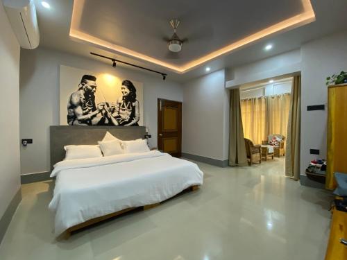 a bedroom with a large bed and a painting on the wall at Magen Homestay in Imphal