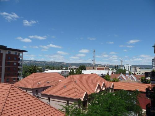 a view of roofs of buildings in a city at City Getaway 3 Bedroom Adelaide's East End in Adelaide