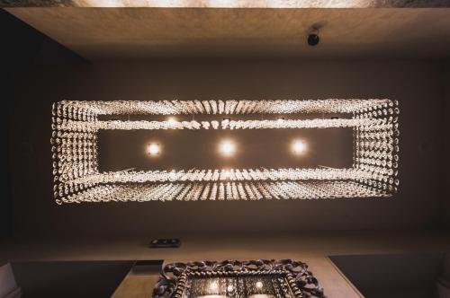 a chandelier hanging from a ceiling in a room at Araba Fenice Hotel in Iseo