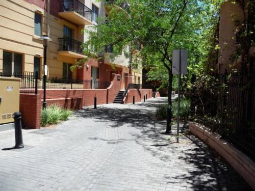 a brick walkway in a city with trees and buildings at City Escape 3 Bedroom East End of Adelaide in Adelaide