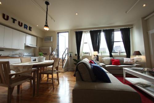 a kitchen and a living room with a table and chairs at The Box House Hotel in Brooklyn