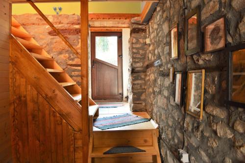 a staircase leading to a door in a log cabin at EskiZ - Our stone home in Chepelare