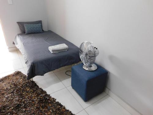 a bedroom with a bed and a trophy on a table at Meteorite Rest Camp in Groutfontein
