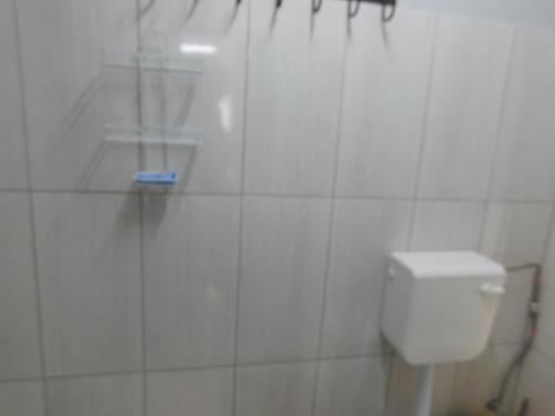 a white bathroom with a shower and a toilet at Meteorite Rest Camp in Groutfontein