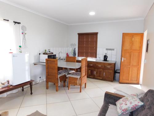 a kitchen with a table and a dining room at Meteorite Rest Camp in Groutfontein