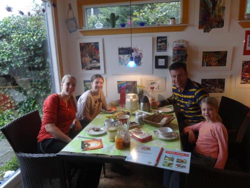 a group of people sitting around a table at Casa Mundo Bed & Breakfast in Vejle