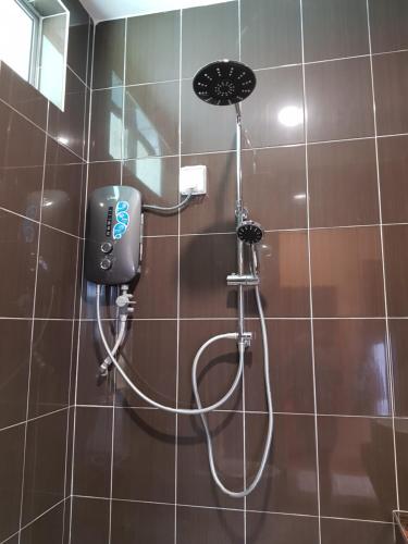 a shower with a blow dryer in a bathroom at DURIAN HILL VILLA in Gua Musang