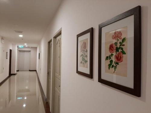 a hallway with paintings on the walls of a house at J.P.GRAND HOTEL in Trat