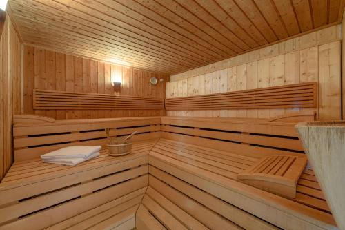 a wooden sauna with two folded towels in it at Mercure Hotel Wiesbaden City in Wiesbaden