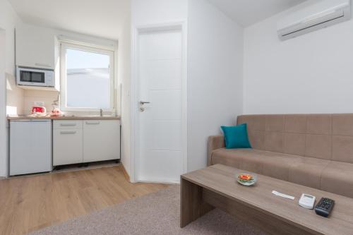 a living room with a couch and a table at Apartments "Tuffo" in Sarajevo