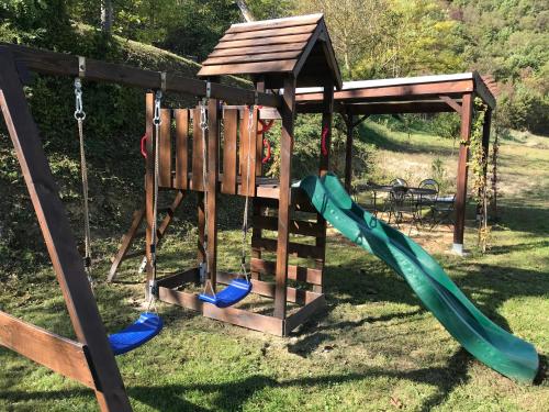 a playground with a slide and a play structure at Villa degli Orti in Acqualagna
