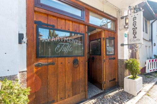 a door to a restaurant with a sign on it at Apartments "Tuffo" in Sarajevo