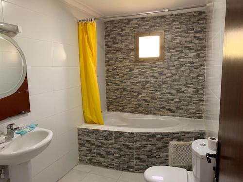 a bathroom with a sink and a bath tub at class hotel in Brazzaville