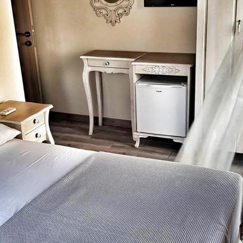 a bedroom with a white desk and a bed at Ege Otel in Cesme