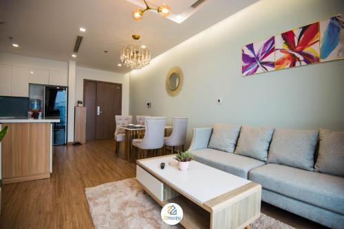 a living room with a couch and a table at Vinhomes Metropolis luxury Hotel & Residence in Hanoi