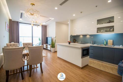 a kitchen and dining room with a table and chairs at Vinhomes Metropolis luxury Hotel & Residence in Hanoi