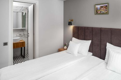 Postel nebo postele na pokoji v ubytování Labirint Boutique Hotel