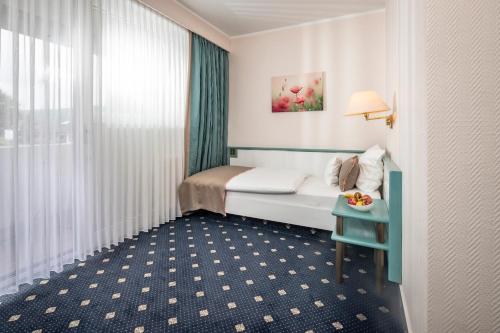 a hotel room with a bed and a table at PANORAMA Hotel Heimbuchenthal in Heimbuchenthal