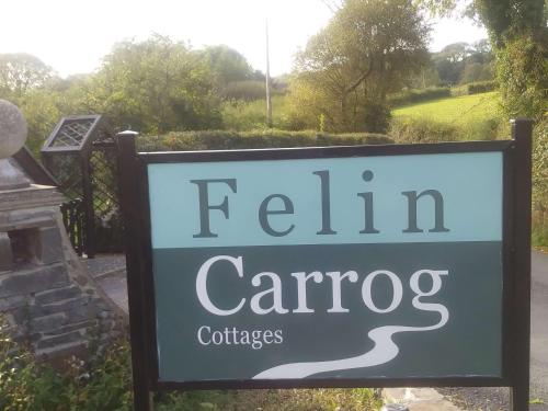 a sign for a train carride with a sign for a garden at Mill Cottage in Llanddeiniol