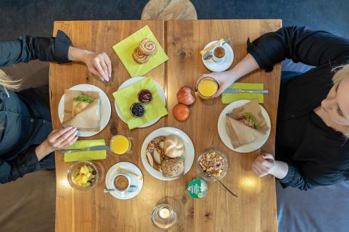 a group of people sitting at a table with food at a2 HOTELS Denkendorf - Airport & Messe in Denkendorf