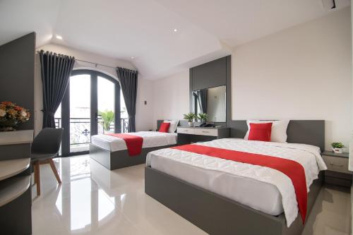 a hotel room with two beds and a mirror at Bin Bin Hotel 7 - Near TON DUC THANG University in Ho Chi Minh City