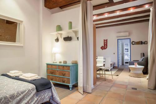 a bedroom with a blue dresser and a living room at Apartamento Horno in Valencia