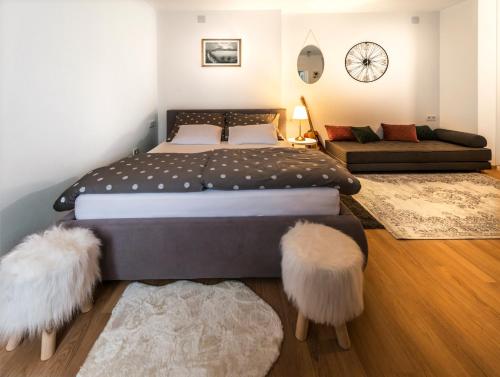 1 dormitorio con 1 cama grande con 2 reposapiés en Zagreb by Heart en Zagreb