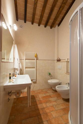 a bathroom with a sink and a tub and a toilet at Agriturismo Il Pelago in Castagneto Carducci