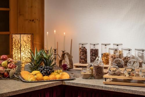 a buffet with fruit and other food on a table at PANORAMA Hotel Heimbuchenthal in Heimbuchenthal