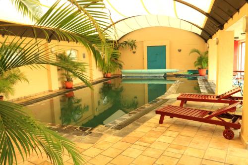 a swimming pool with a bench in a building at 29 The Village in Hout Bay