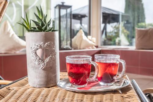 a table with two cups of tea and a vase at PANORAMA Hotel Heimbuchenthal in Heimbuchenthal