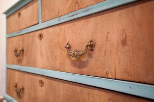 a wooden dresser with a metal handle on it at Apartamento Horno in Valencia