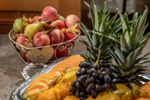 a tray of fruit on a table with a bowl of fruit at PANORAMA Hotel Heimbuchenthal in Heimbuchenthal