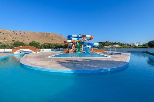 a water park with a water slide in the water at Olive Garden Hotel in Lardos