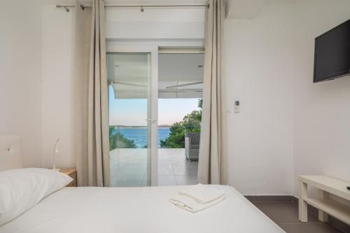a bedroom with a bed and a view of the ocean at Villa Oceanus in Hvar