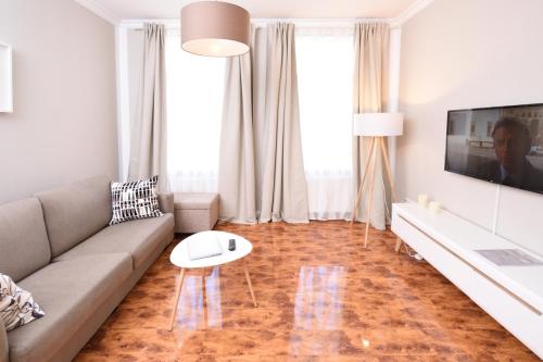 a living room with a couch and a table at Apartments-Leipzig in Leipzig