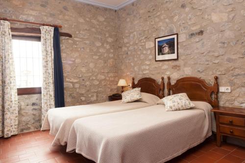 Postel nebo postele na pokoji v ubytování Hostal de la Rovira