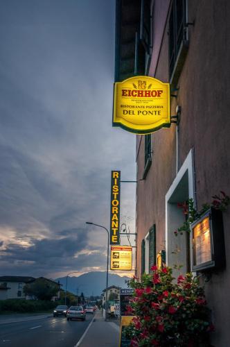 a yellow sign on the side of a building at Ristorante Del Ponte in Cugnasco