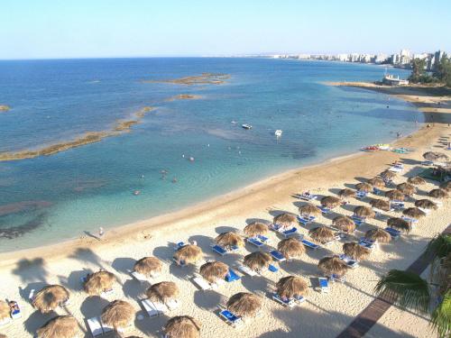 an aerial view of a beach with umbrellas and the ocean at RiX Studio Park Famagusta Contactless Check In & Check Out in Mağusa
