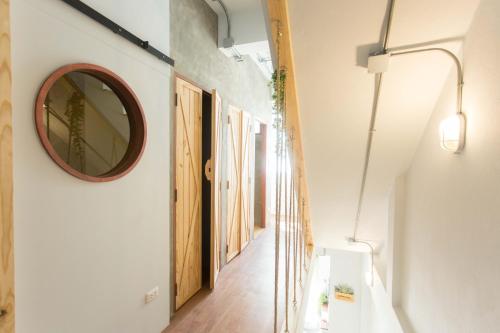 a hallway with a mirror on the wall at Barn & Bed Hostel in Bangkok