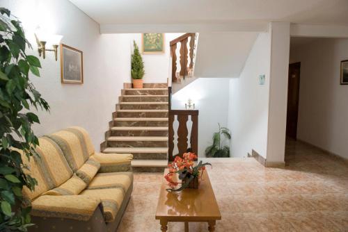 a living room with a couch and a table and stairs at Hotel Sierra Mar in La Unión