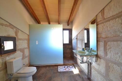 a bathroom with a toilet and a sink at Finca Els Tarongers 081 by Mallorca Charme in Muro