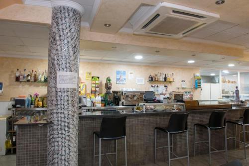 a bar in a restaurant with black stools at Hotel Sierra Mar in La Unión